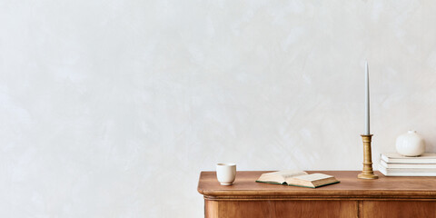 Minimalist composition of living room with wooden commode, table lamp, dried flower in vase, book, decoration and elegant personal accessories in stylish home decor. Template. Copy space.