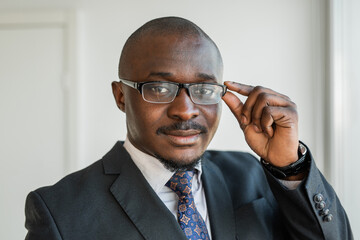 portrait of an adult african businessman with glasses 