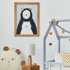 Stylish scandinavian child's room interior with mock up poster frame, creative bed, wooden cube, lamp, plush and wooden toys and hanging textile decorations. Grey wall, carpet on the floor. Template.