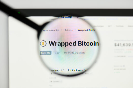 Milan, Italy - January 11, 2022: wrapped bitcoin - WBTC website's hp.  wrapped bitcoin, WBTC coin logo visible through a loope. Defi, ntf, cryptocurrency concepts illustrative editorial.
