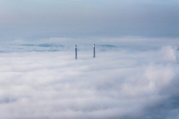 Fototapeta na wymiar vue aérienne des cheminées de l'usine thermique de Porcheville dans la brume dans les Yvelines en France