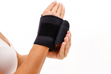 Woman hand with a wrist and finger brace, orthopeadic equipment over white