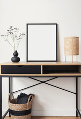 Blank picture frame mockup on white wall. White living room design. View of modern scandinavian style interior with artwork mock up on wall. Home staging and minimalism concept