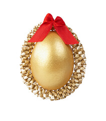 A golden Easter egg and red bow isolated on white.