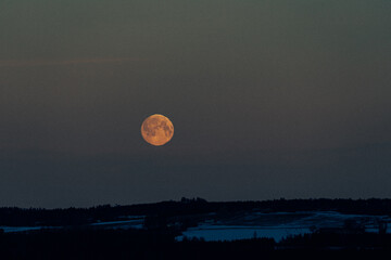 The full moon above rural Toten, Norway.