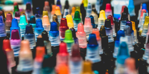 Fototapeta Many bottles with colorful inks for tattoo, close up view obraz