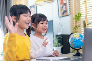 Asian girl student online learning class study online video call zoom teacher, Happy girl learn english language online with laptop at home.New normal.Covid-19 coronavirus.Social distancing.stay home