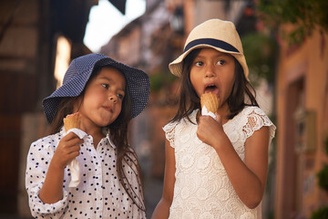 Cute Asian girl enjoying eating an ice cream in summer sunshine