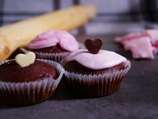 Chocolate cupcakes decorated with icing and chocolate love hearts