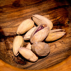 Pistachio nuts with rosemary on wooden background,top view,copy space