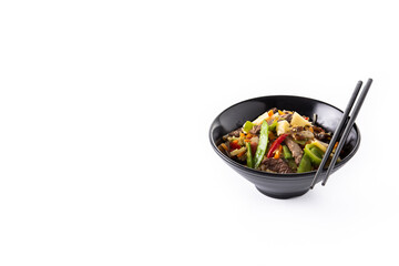 Beef, vegetables and sesame seeds in black bowl isolated on white background. Copy space	