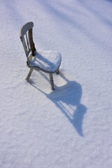 old wooden chair abandoned on the snow - 480927198