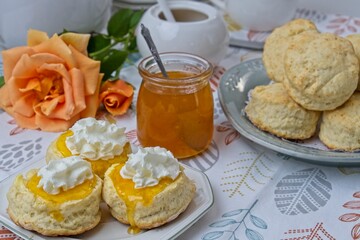 Close up of scones topped with whipped cream