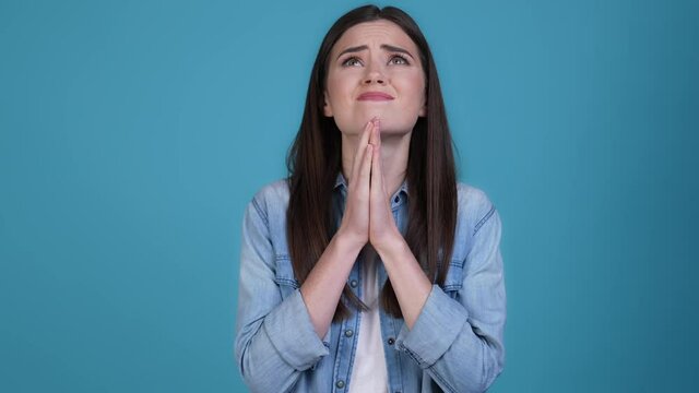 Scared lady expect want cross fingers isolated blue color background