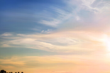 Sunset (sunrise) sky with fluffy light clouds soft focus. Heavenly colored pastel  background. Concept of freedom, relaxation, ecology. Copy space. Empty space for message.