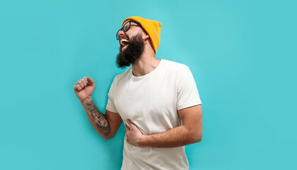 A sick man is in severe pain due to gallstones. A young man with a beard suffers from gallbladder disease. Copy space for your text.