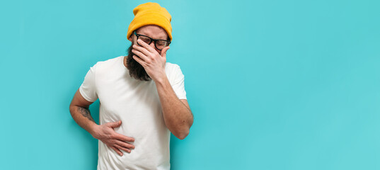 A sick man is in severe pain due to gallstones. A young man with a beard suffers from gallbladder...