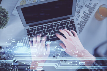Double exposure of man's hands typing over computer keyboard and data theme hologram drawing. Top view. Technology concept.