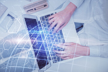 Double exposure of woman hands working on computer and world map hologram drawing. Top View....
