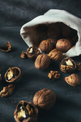 Sack of walnuts with copy space in dark mood shot.