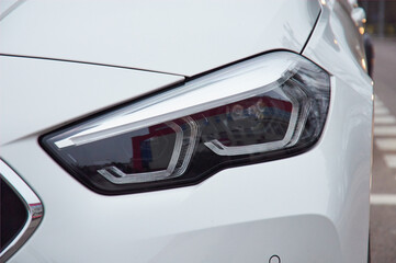 Modern car headlights. Exterior detail.Closeup headlights of car.