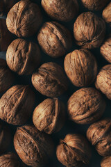 Top view of walnuts texture in dark mood shot with copy space.