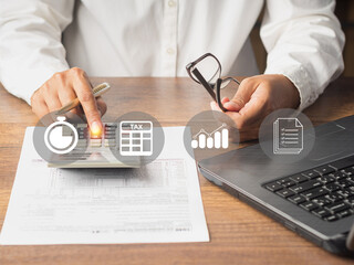 Tax payment and calculation tax return. Businessman using a calculator and complete individual...