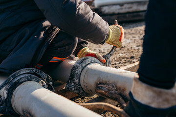 Workers stack iron pipes for pouring concrete before building a bridge