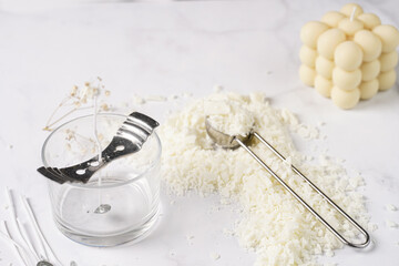 Tools and supply for candle-making: wicks, soy and coconut wax, gold foil, colors and aroma oils, bubble candle