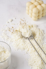 Tools and supply for candle-making: wicks, soy and coconut wax, gold foil, colors and aroma oils, bubble candle