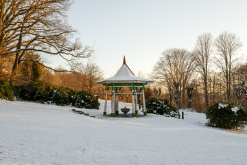 Wooden pavilion of mineral water spring in winter - public park of small climatic spa town Lazne...