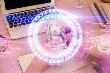 Multi exposure of blockchain theme drawing hologram and USA dollars bills and man hands. Business concept.