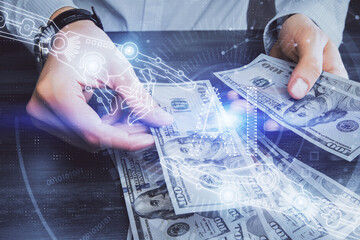 Double exposure of technology drawing hologram and us dollars bills and man hands. Data concept