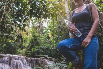 asian young woman attractive traveler  adventure wilderness hold bottle of water.