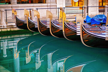 Detail on the steel bow of Venetian gondolas moored in Venice, Italy. © Mike Dot