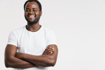 Black man laughing while posing with arms crossed