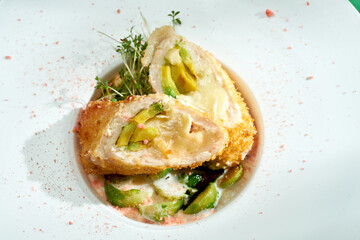 Chicken Kiev cutlet with Brussels sprouts in a white plate. Colored backgrounds. Hard light. selective focus