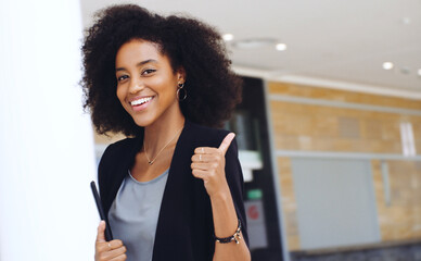 It's all systems go. Portrait of a confident young businesswoman showing a thumbs up gesture in a...
