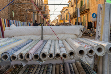 Rolls of cloth displayed at a street martket