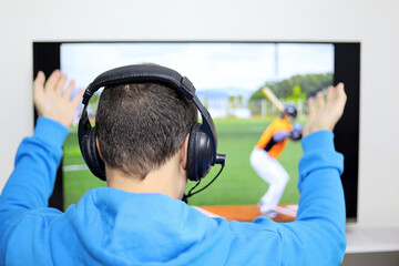 Man in headphones watching baseball match on TV screen. Disappointed or shocked fan worried about...