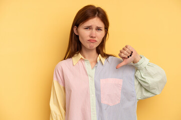 Young English woman isolated on yellow background showing thumb down, disappointment concept.
