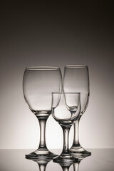 Glassware of different sizes against monochrome background