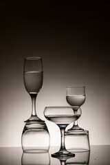 Glassware of different sizes against monochrome background