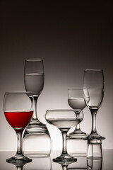 Glassware of different sizes against monochrome background