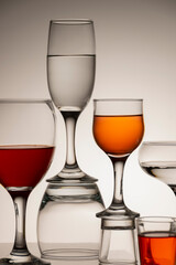 Glassware of different sizes against monochrome background