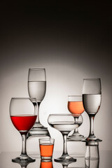 Glassware of different sizes against monochrome background