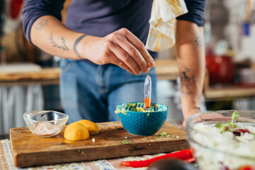 man preparing dressing for salad
