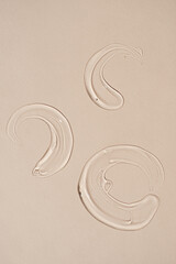 Beauty, skincare product setting. Transparent cosmetic gel smear on neutral beige background