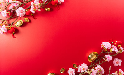 Chinese new year decorations made from red packet, orange and gold ingots or golden lump on a red background. Chinese characters FU in the article refer to fortune good luck, wealth, money flow.