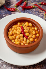 Hot turkish bean stew on wooden background. Ispir beans cooked in a casserole - Kuru Fasulye